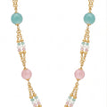 Necklace with gold chain and multicolored beads on a white background