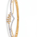 Gold bracelet with diamond accents on a white background