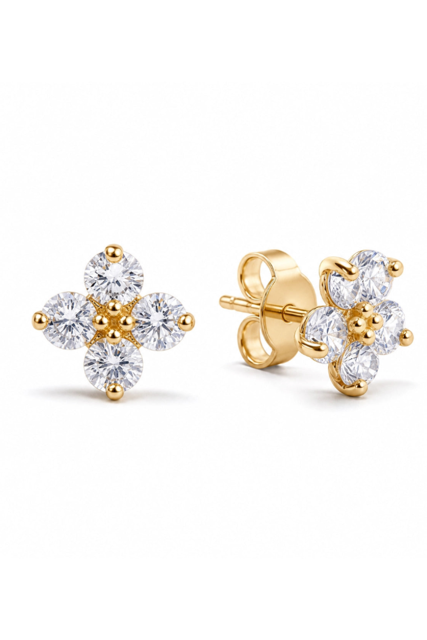 Gold and crystal flower-shaped earrings on a white background