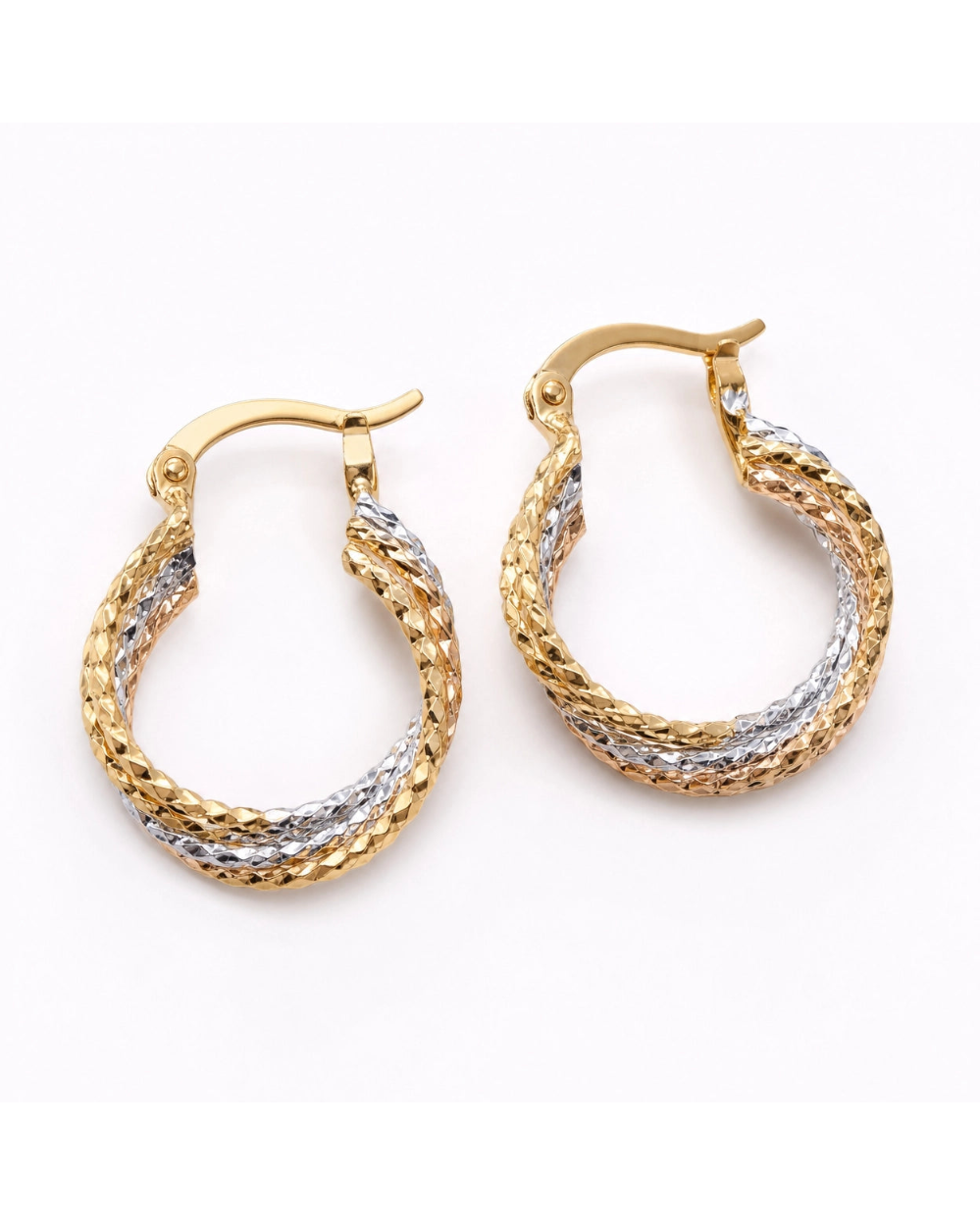 Pair of gold and silver hoop earrings on a white background